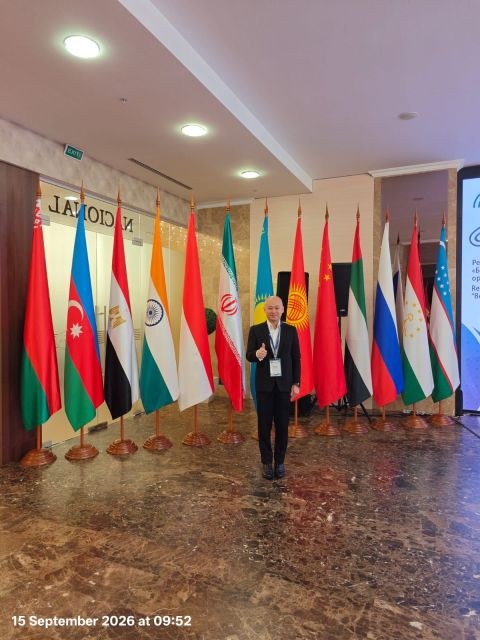 Raymond Cheung at the Belarus Re conference venue with international flags